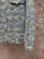Blue denim jacket with all-over monogram pattern, front flap pockets, and button closure
