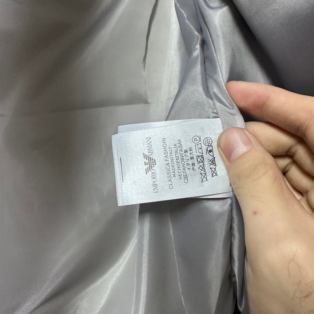 Amiri hooded puffer vest, light gray, care label tag near inner seam