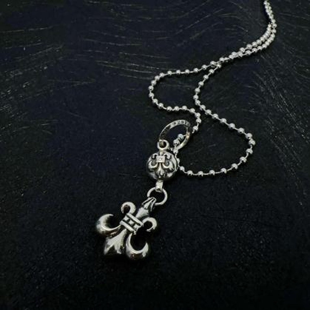 Chrome accessory necklace with anchor charm and small key-like detail