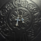 Silver-tone cross pendant necklace with blue gem accents and double chain