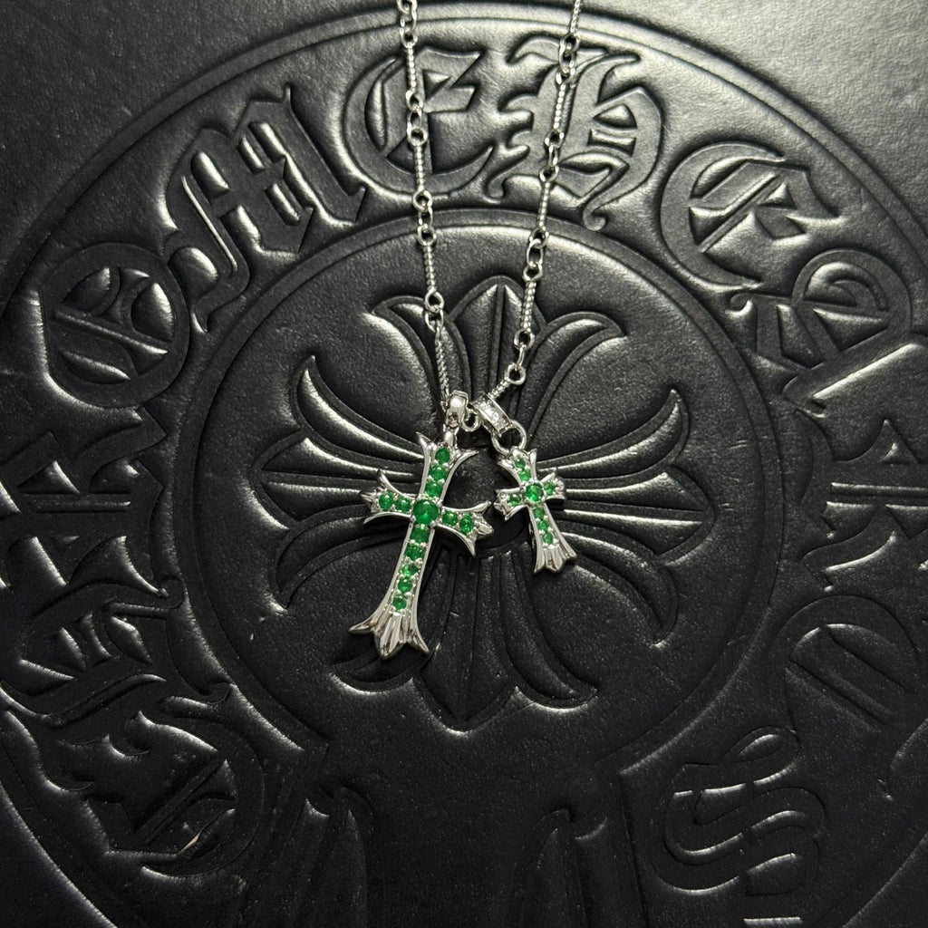 Silver-tone cross pendant necklace with green gem accents and double chain