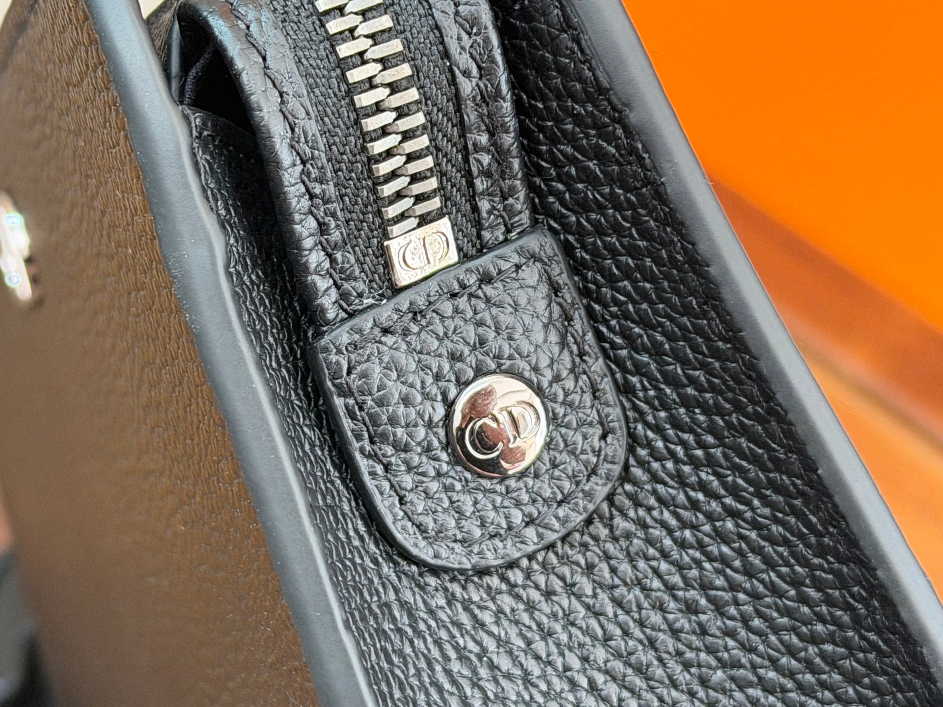 Dior small bag close-up of front pocket with CD emblem and zipper