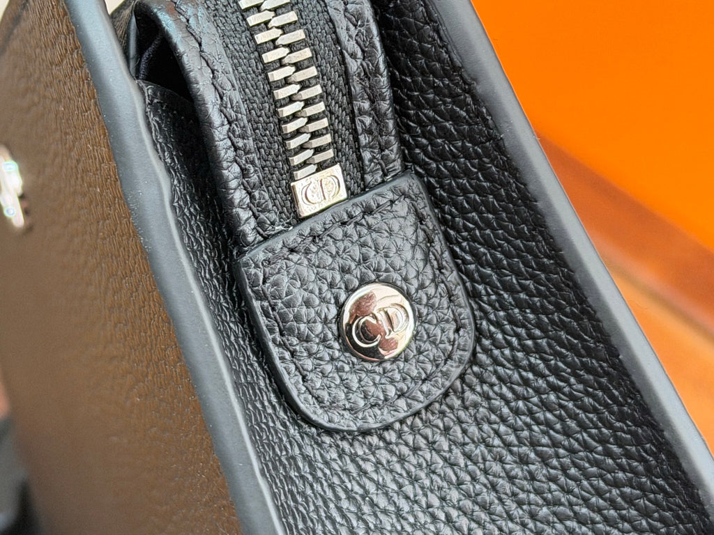Dior bag front clasp with CD medallion on textured dark pebbled leather