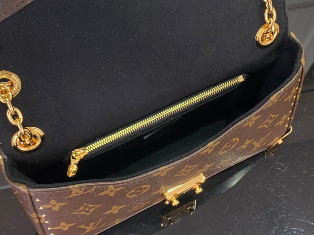 Louis Vuitton monogram canvas bag interior with zip pocket and gold zipper pull