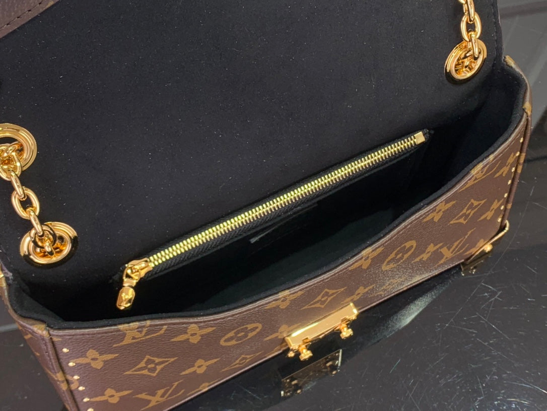 Louis Vuitton monogram canvas bag interior with zip pocket and gold zipper pull