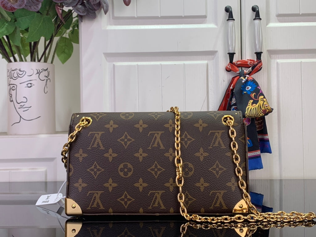 Louis Vuitton monogram canvas handbag with gold-tone chain strap and front flap