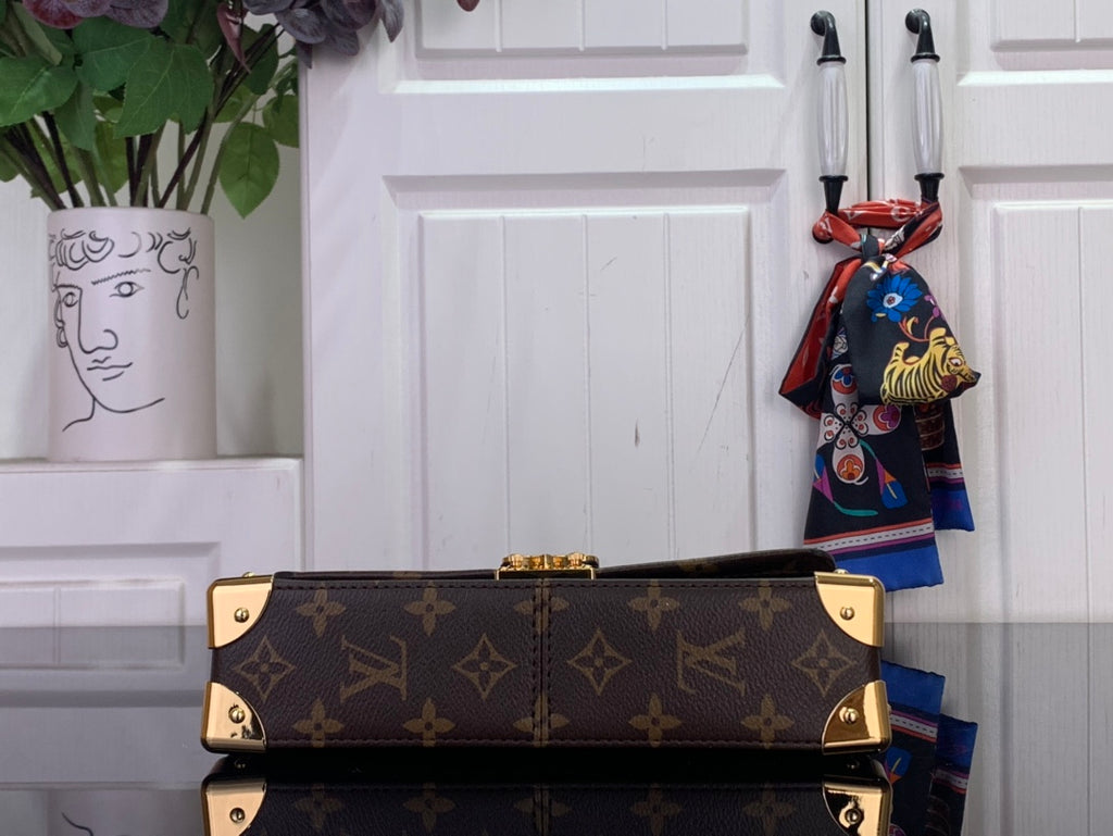 Louis Vuitton monogram canvas bag with gold-tone hardware and top handle detail