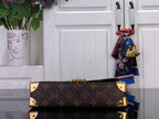 Louis Vuitton monogram canvas bag with gold-tone hardware and top handle detail