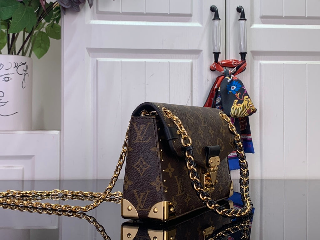 Louis Vuitton monogram canvas bag with gold-tone chain strap and turn-lock clasp
