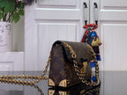 Louis Vuitton monogram canvas bag with gold-tone chain strap and turn-lock clasp