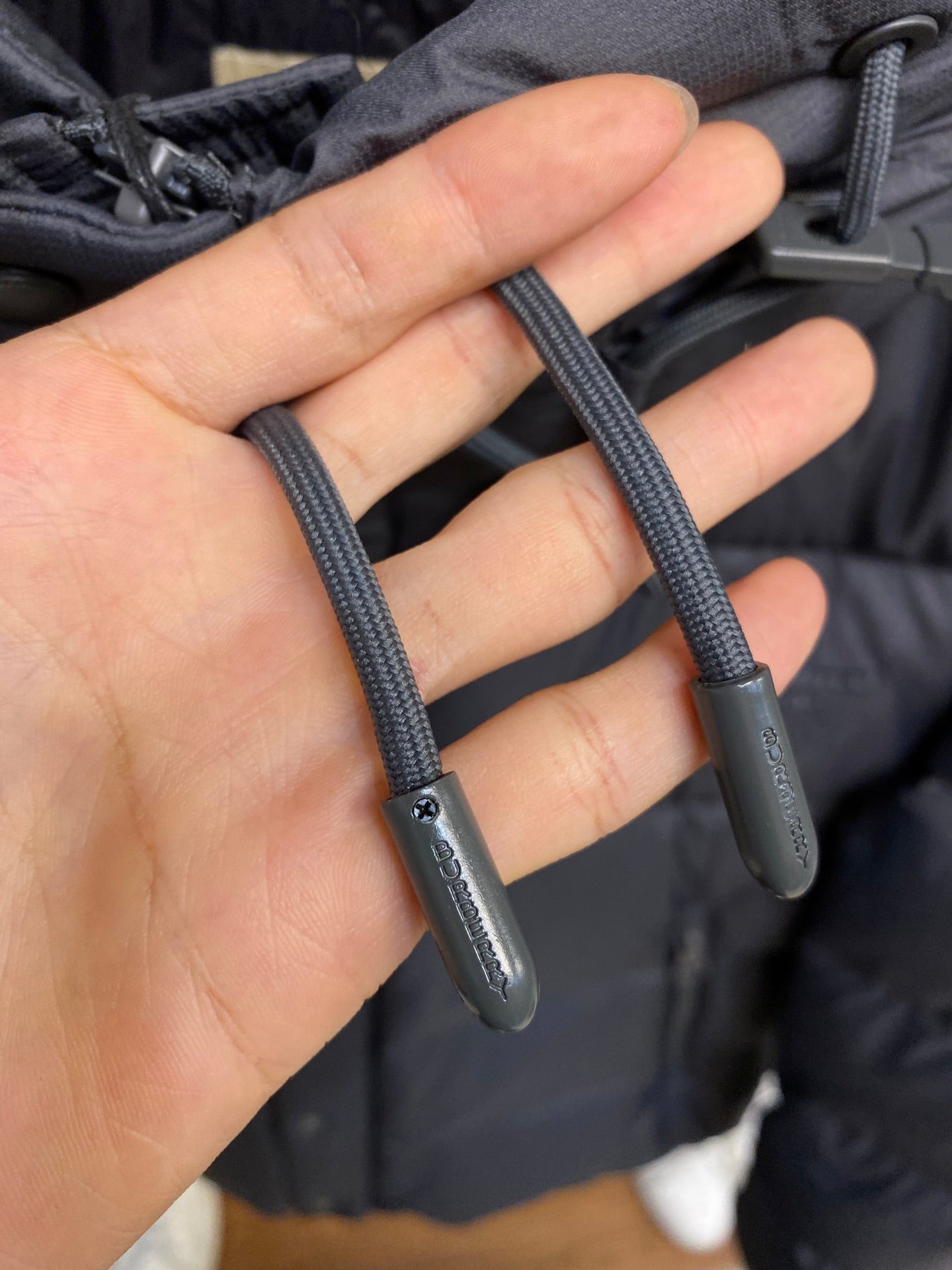 Dark gray puffer jacket drawstring cords with metal tips