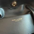 Saint Laurent leather label text: “SAINT LAURENT PARIS ITALY” on black bag