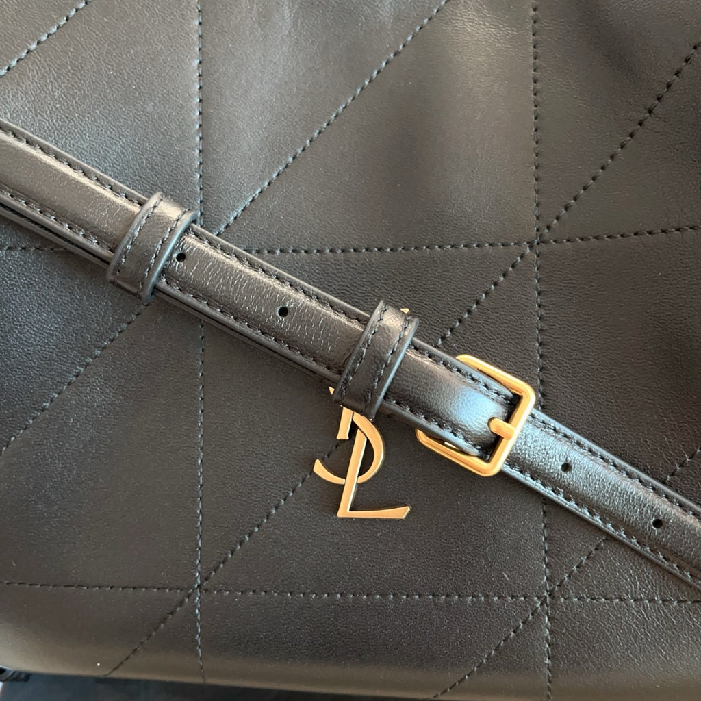 Saint Laurent strap with gold buckle detail on black quilted leather bag