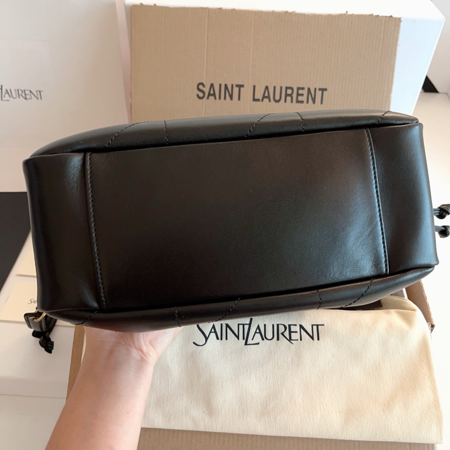 Saint Laurent black leather bag with gold chain strap and top seam detail