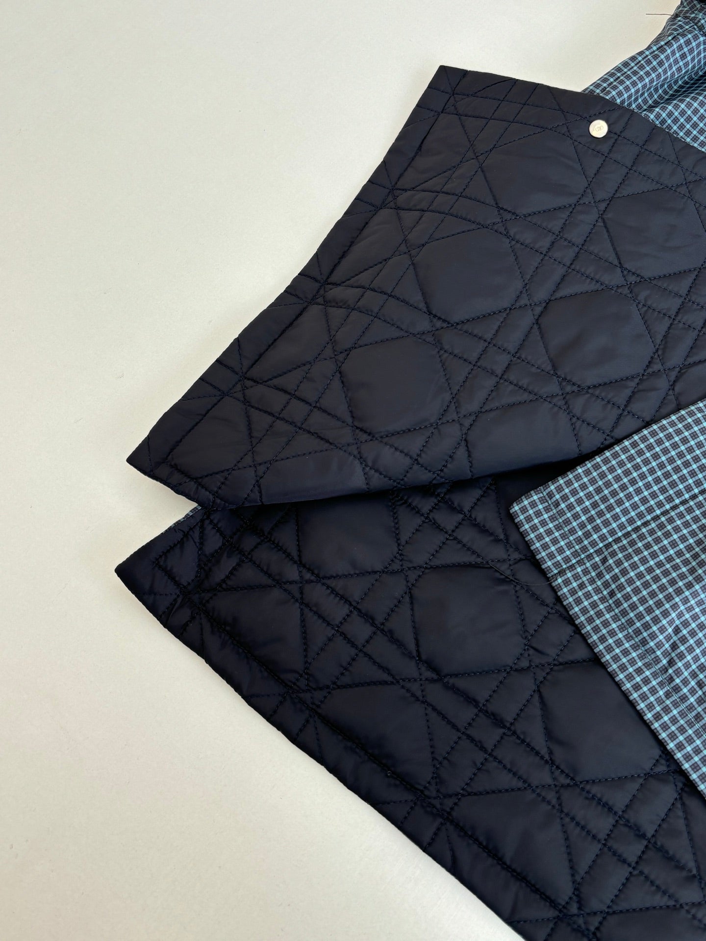 Navy quilted inner lining pieces with buttoned edges