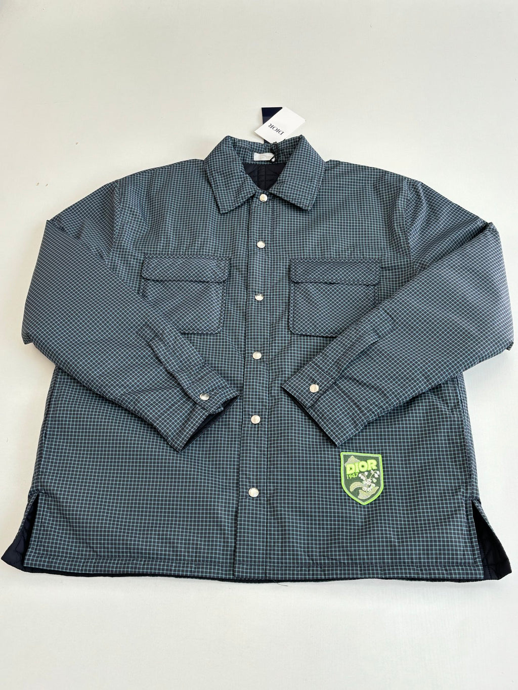 Blue check button-up jacket with two flap chest pockets and Dior logo patch