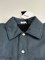 Blue check shirt jacket with pointed collar, front buttons, and matching pocket flaps