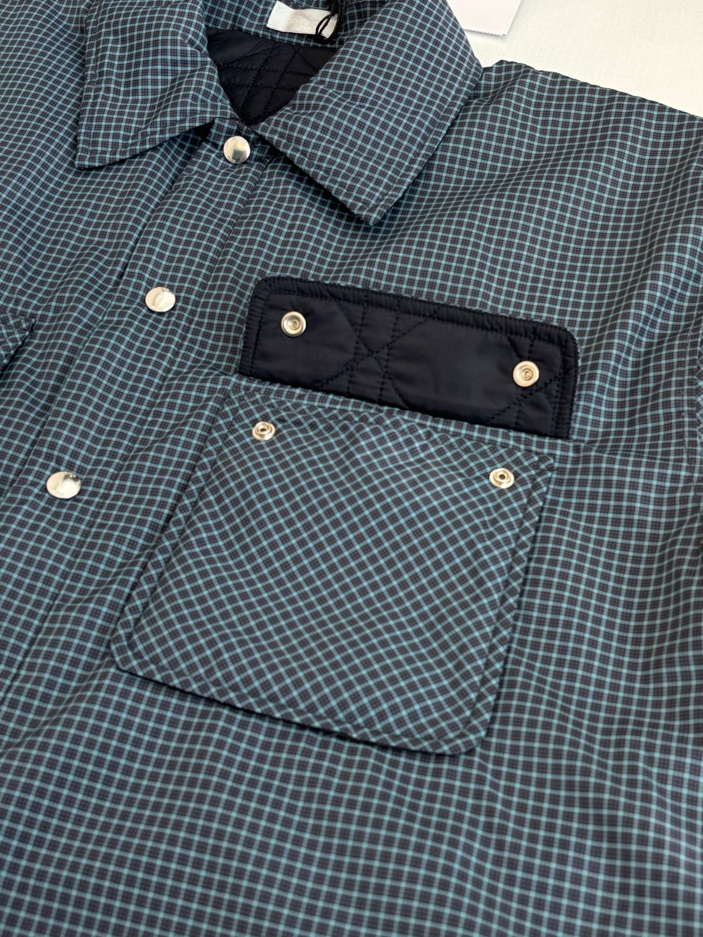 Blue check jacket with front buttons and rectangular snap pocket panel