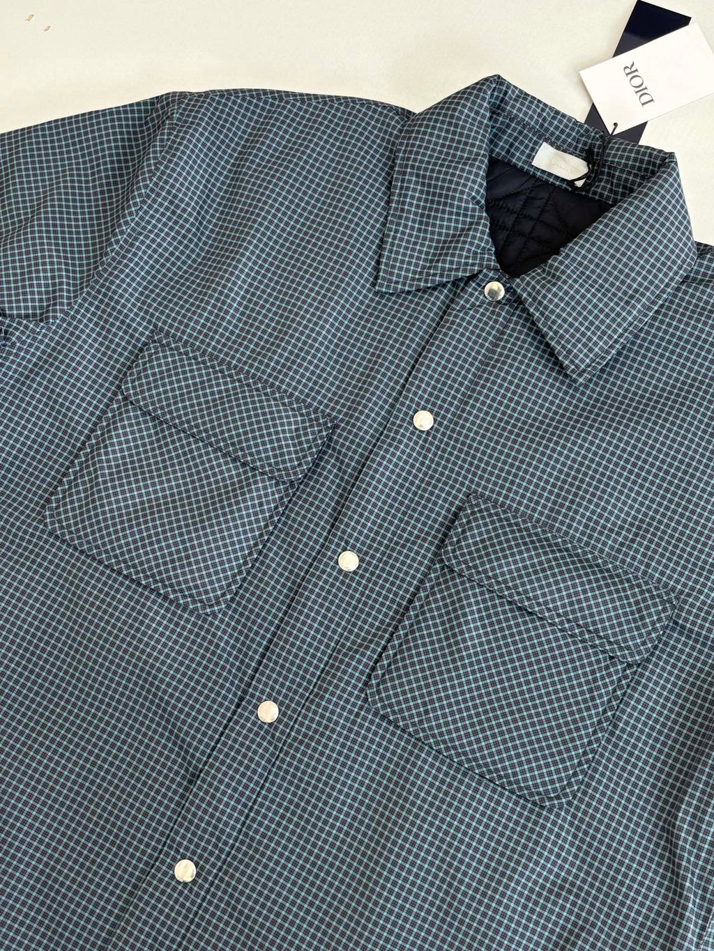 Blue check long-sleeve jacket with front buttons and flap pockets
