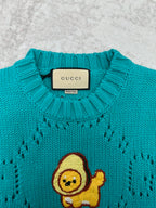 Turquoise crewneck sweater with ribbed collar and Gucci label at neckline