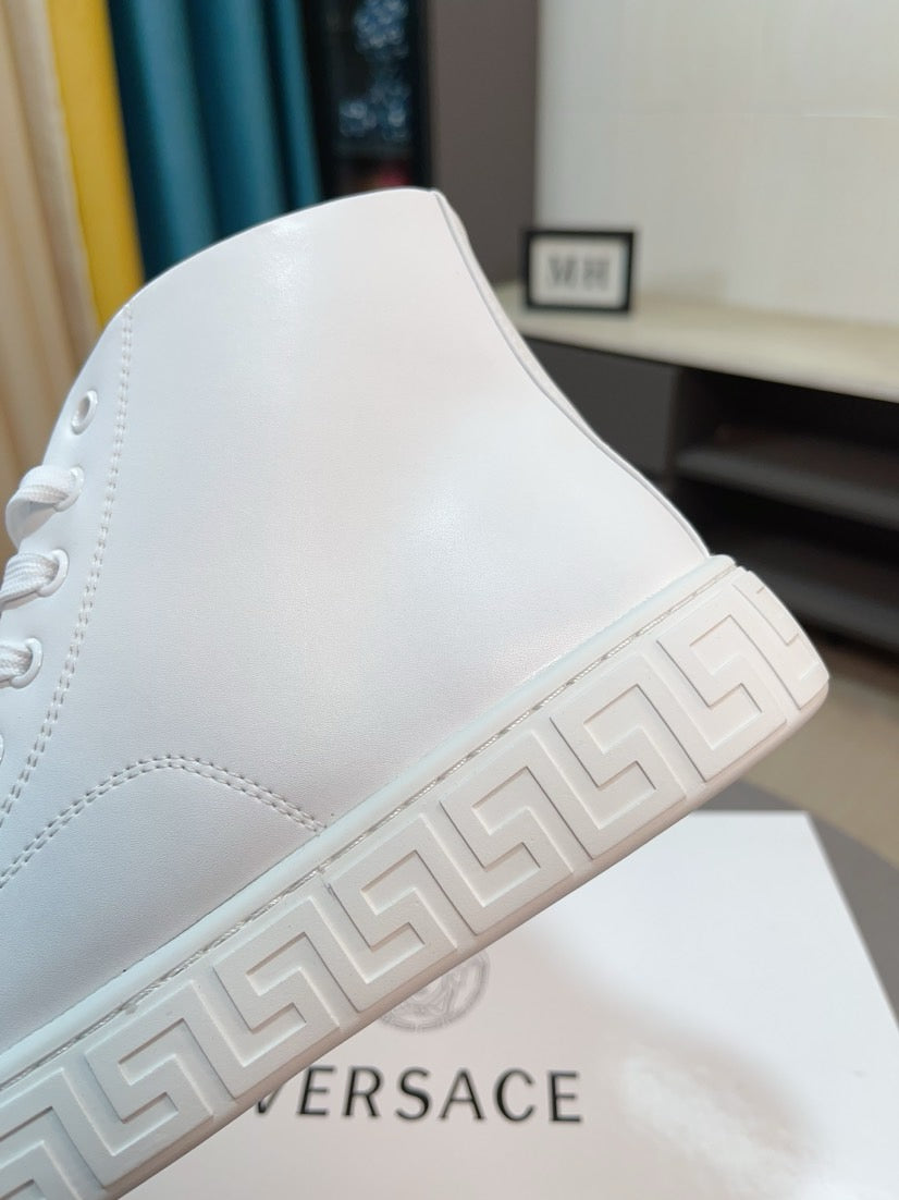 White high-top sneaker with Greek-key style sidewall on the sole.
