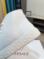 White high-top sneaker with Greek-key style sidewall on the sole.