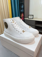 Pair of white lace-up high-top sneakers with logo patch and textured side stripe.