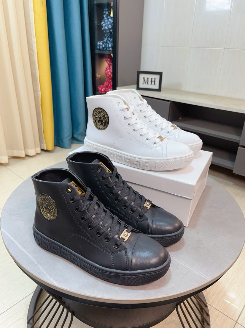 Pair of lace-up high-top sneakers, black and dark tone with logo patch.