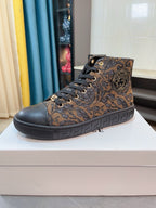 Lace-up high-top sneakers with ornate paisley pattern, dark upper and black rubber sole.