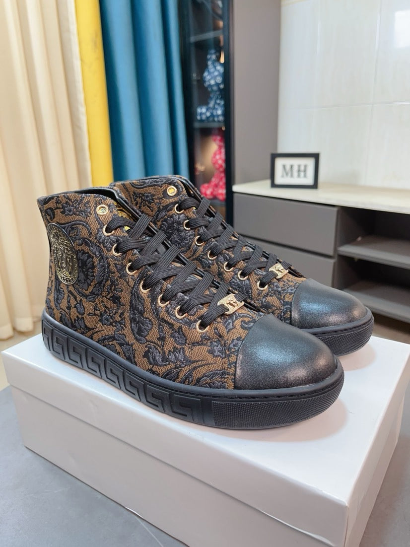 Two lace-up high-top sneakers with dark paisley fabric uppers and textured black rubber soles.