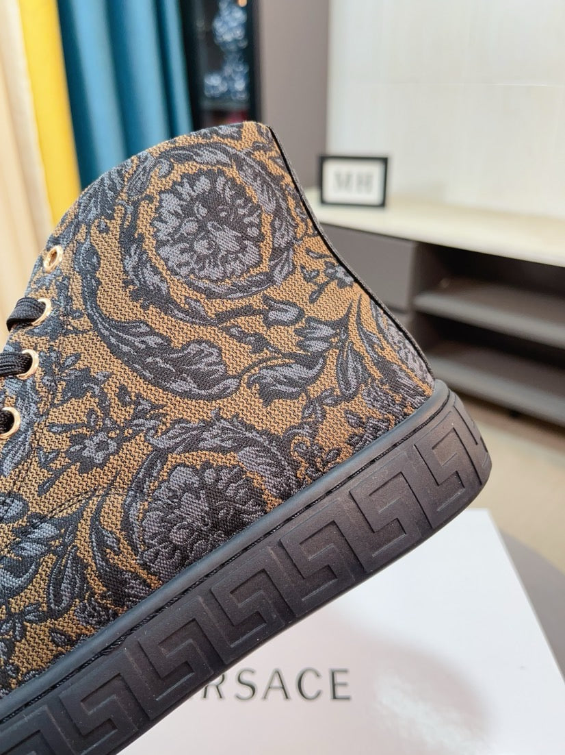 Side view of lace-up high-top sneaker: brown paisley upper with textured embossed sole.
