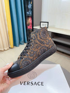 Lace-up high-top sneaker with brown paisley jacquard upper, black toe cap, rubber sole.