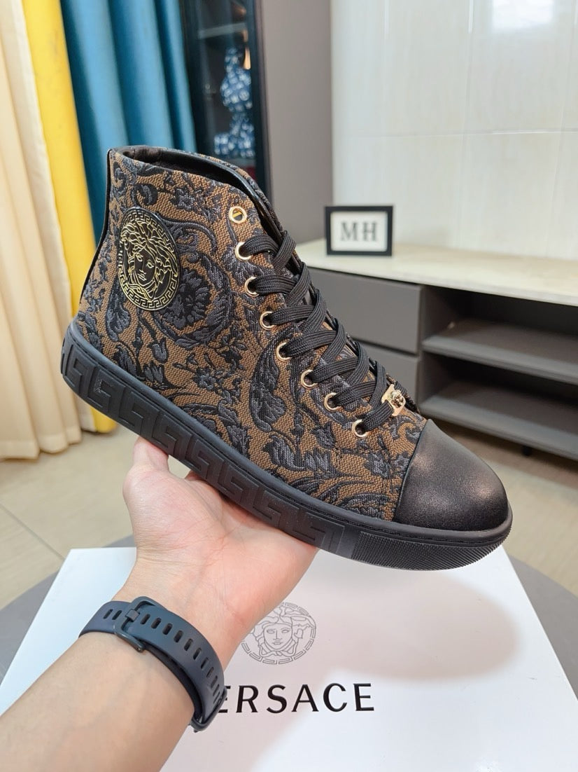 Lace-up high-top sneaker in dark brown with ornate paisley print and black rubber sole.