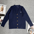 Navy cable-knit cardigan with front button placket and small polo horse emblem