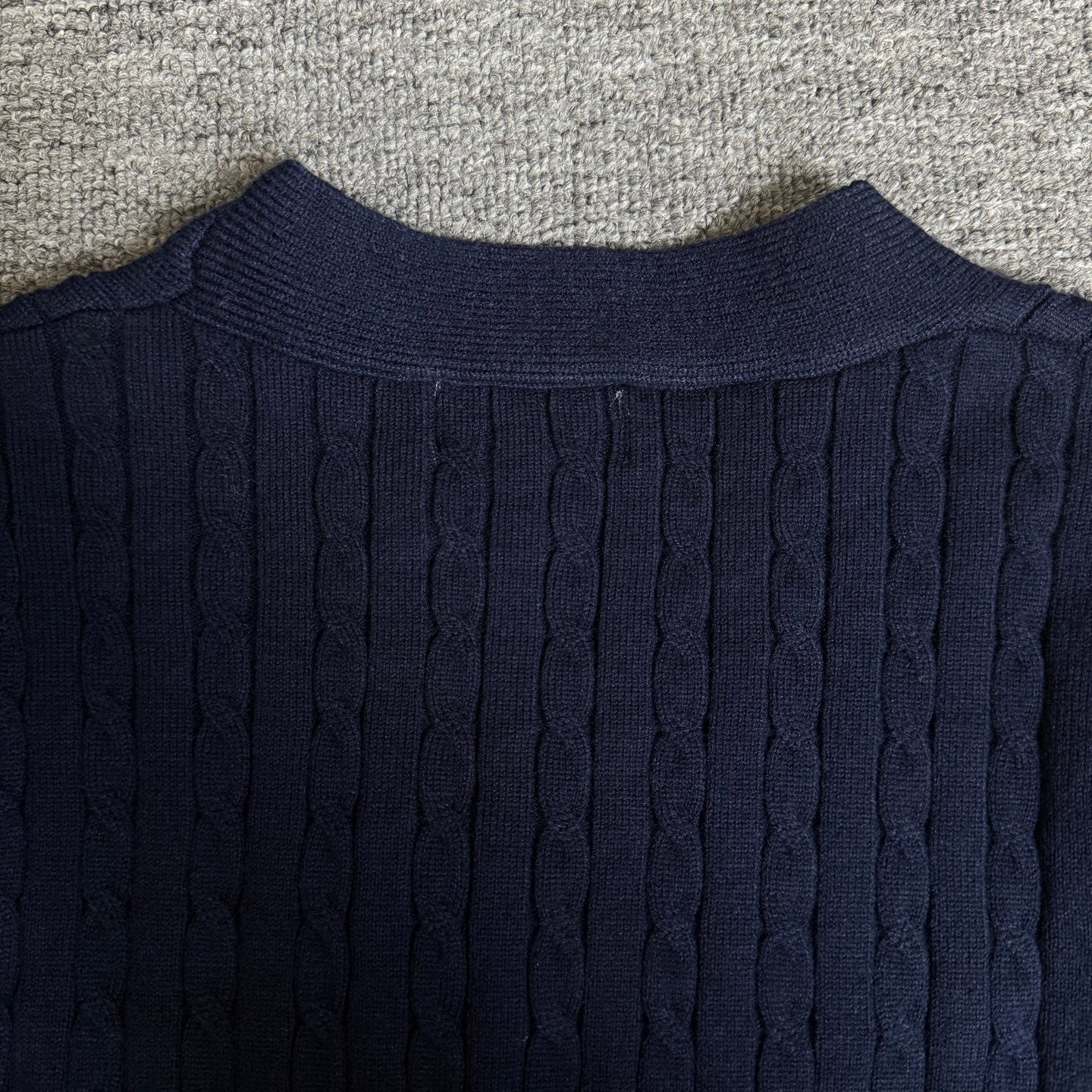Navy cable-knit cardigan back with ribbed crew neckline