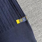 Navy knit sleeve cuff with ribbed trim and yellow size label