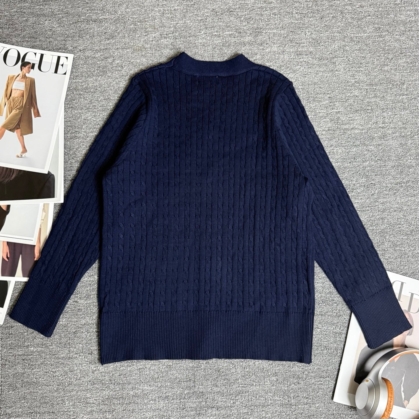 Navy cable-knit sweater/cardigan with ribbed hem and full-length sleeves