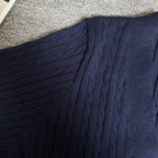 Navy cable-knit cardigan shoulder and upper panel with textured ribbed pattern