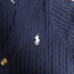 Navy cable-knit cardigan with embroidered polo horse emblem and button edge