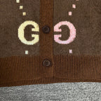 Brown Gucci logo knit cardigan button-front close-up with GG motifs and ribbed hem.