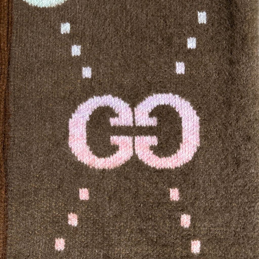 Brown Gucci logo knit cardigan close-up of GG lettering with dotted motif knit pattern.