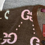 Brown Gucci logo knit cardigan close-up of oversized GG letters and dotted accents.
