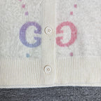 Gucci knit cardigan front detail with two buttons and colorful GG letters on off-white