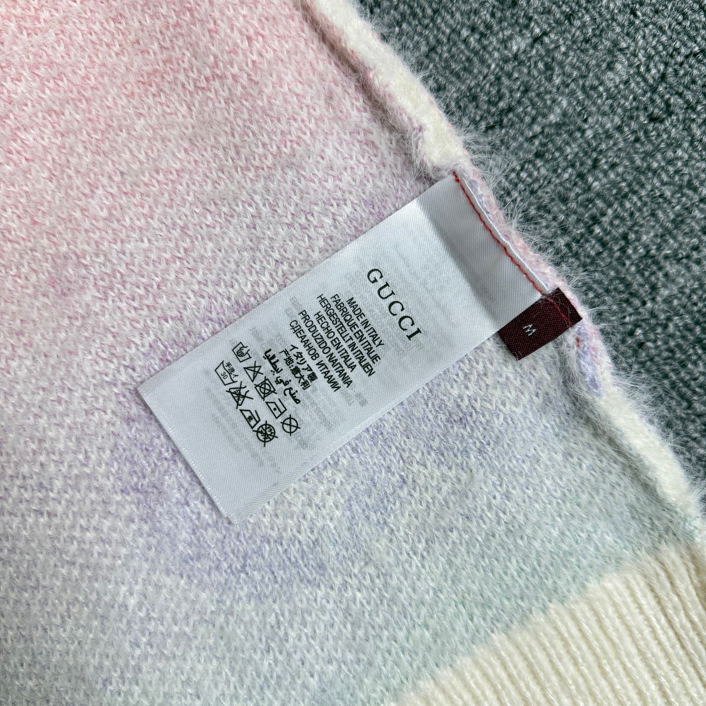 Gucci knit cardigan inside neck label on off-white knit near hem edge