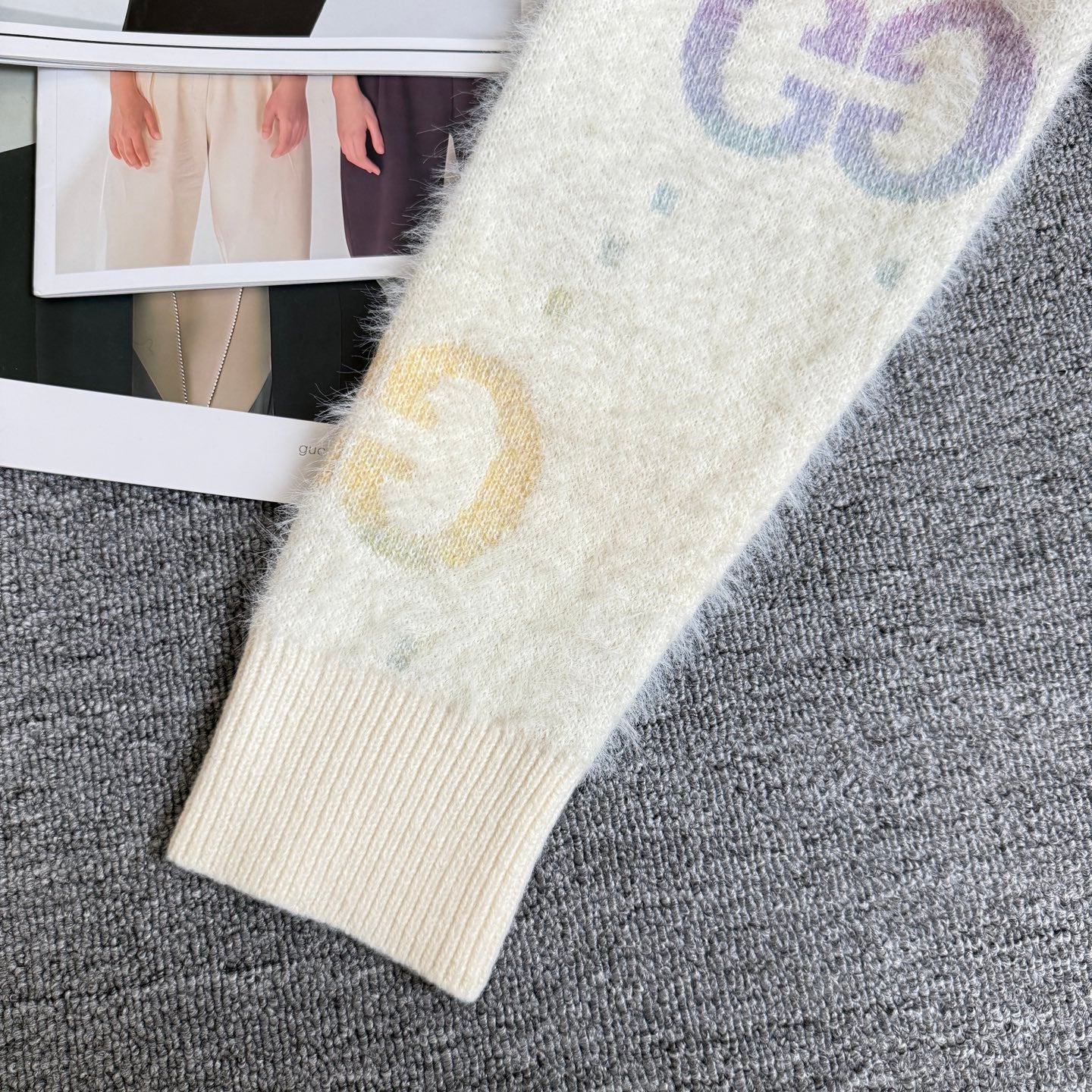 Gucci knit cardigan cuff detail, off-white sleeve with yellow and blue GG logo