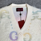 Gucci knit cardigan neckline with Gucci label and button placket on off-white fabric