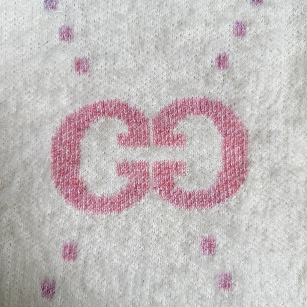 Gucci knit cardigan detail: large pink GG logo on off-white knit with small speckles