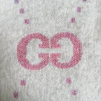 Gucci knit cardigan detail: large pink GG logo on off-white knit with small speckles