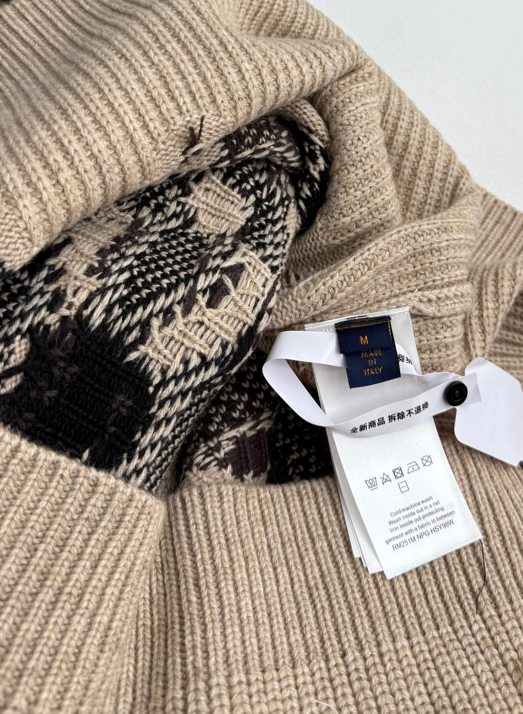 Beige knit sweater with Louis Vuitton tag and patterned cuff detail