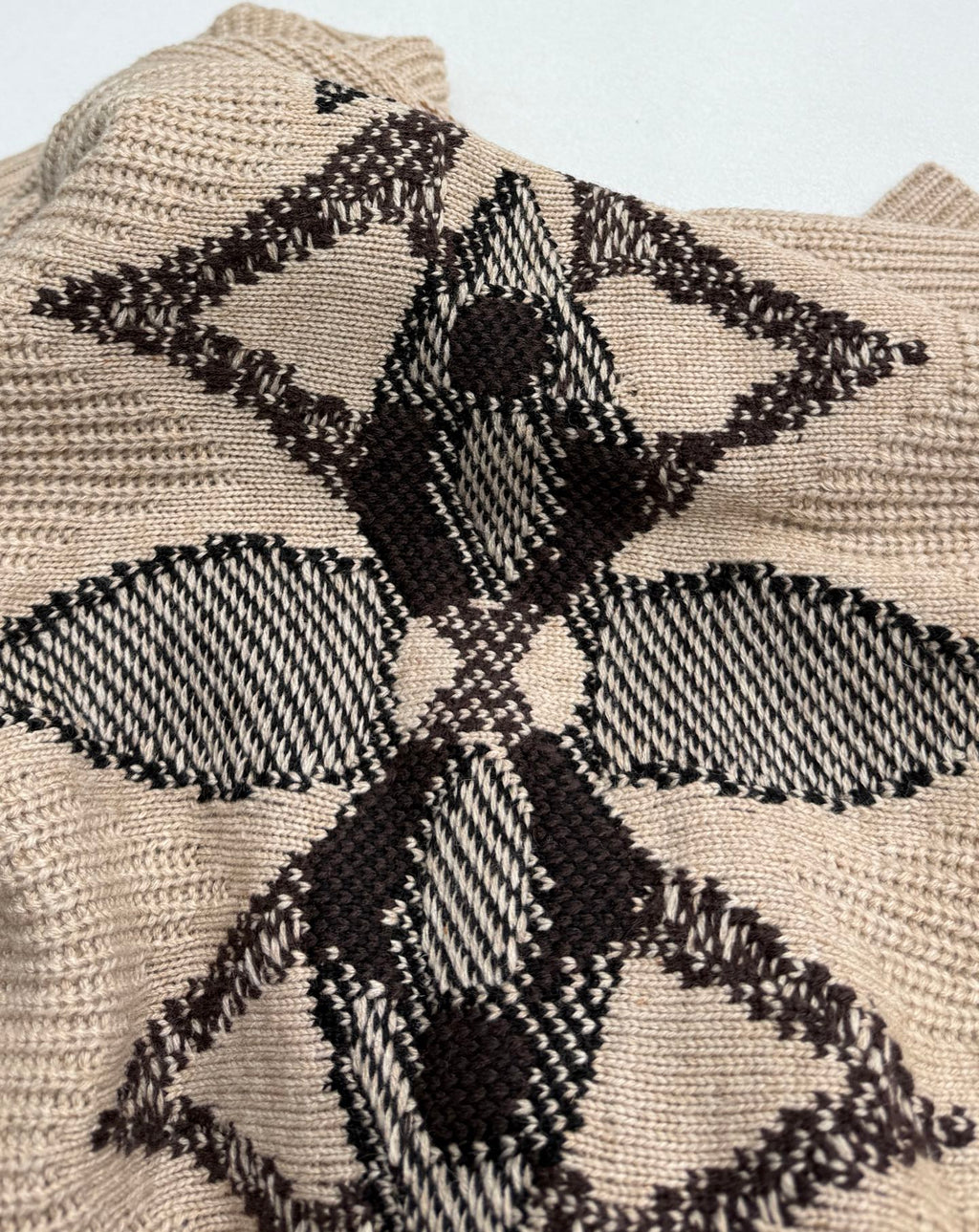 Beige knit sweater with large black geometric floral intarsia